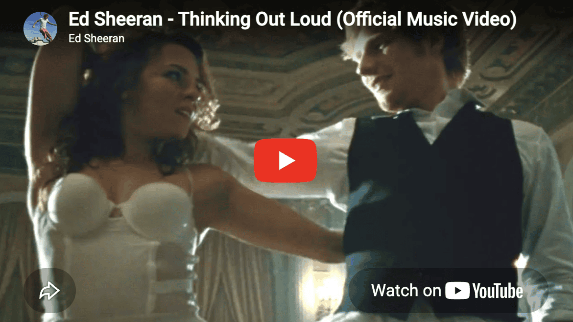 A still from the official music video for Ed Sheeran's 'Thinking Out Loud', showing him dancing with his partner.